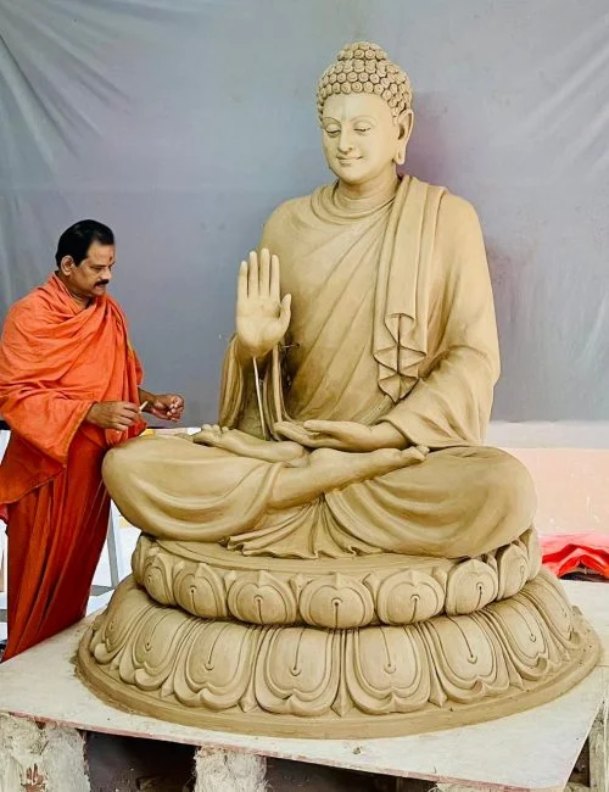 Rajkumar Vudayar shaping a large seated Buddha statue