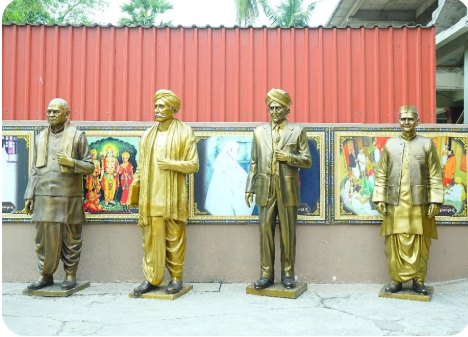 Golden statues of leaders in a public setting